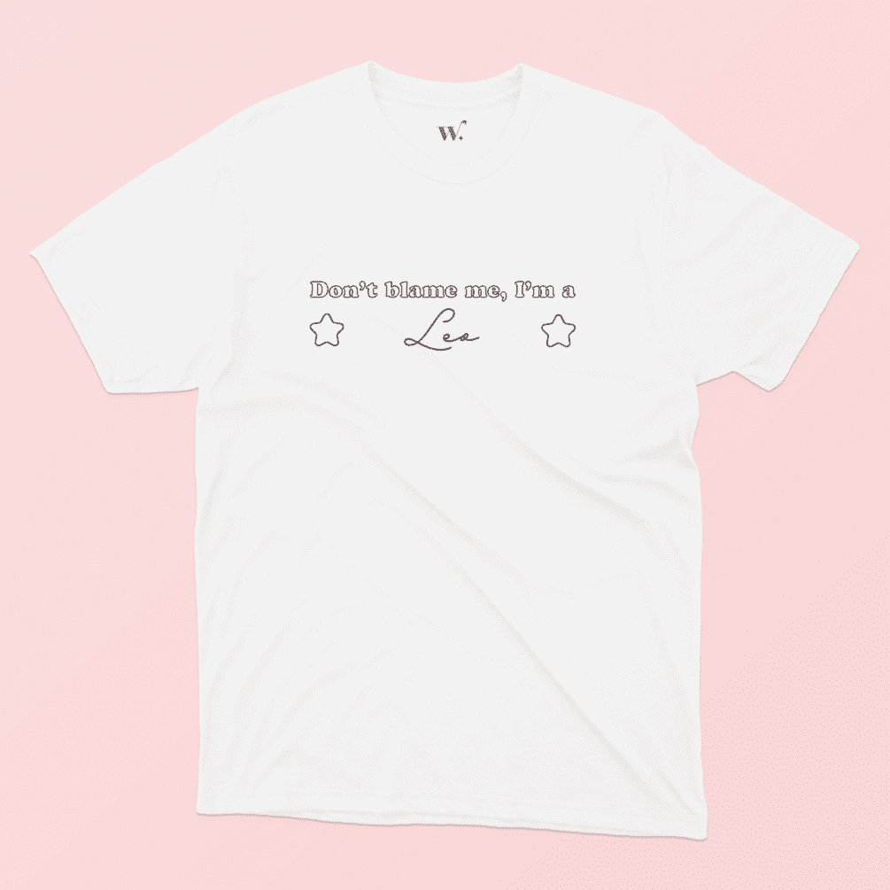 Don't blame me I'm a Leo illustrated white t-shirt on a pink background