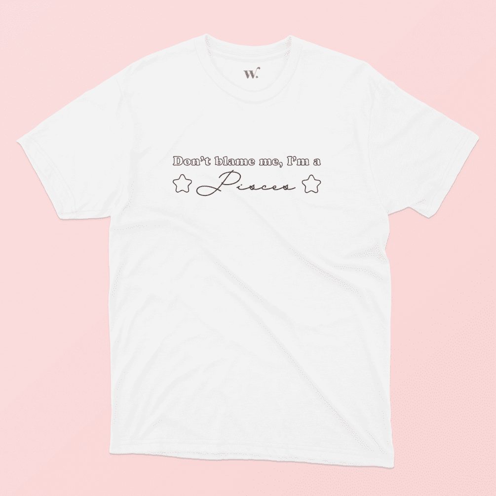 Don't blame me I'm a Pisces illustrated white t-shirt on a pink background