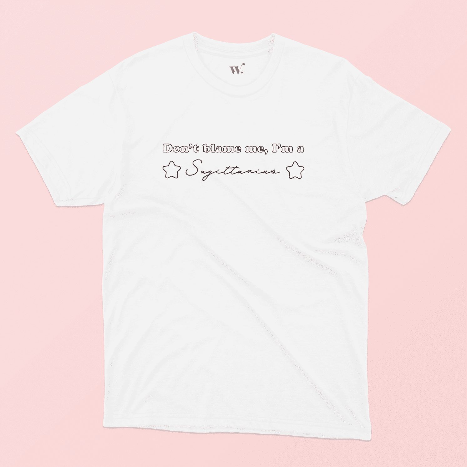 don't blame me I'm a Sagittarius illustrated white t-shirt on a pink background