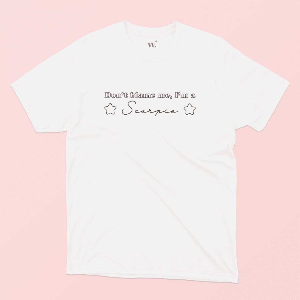 Don't blame me I'm a scorpio illustrated white t-shirt on a pink background