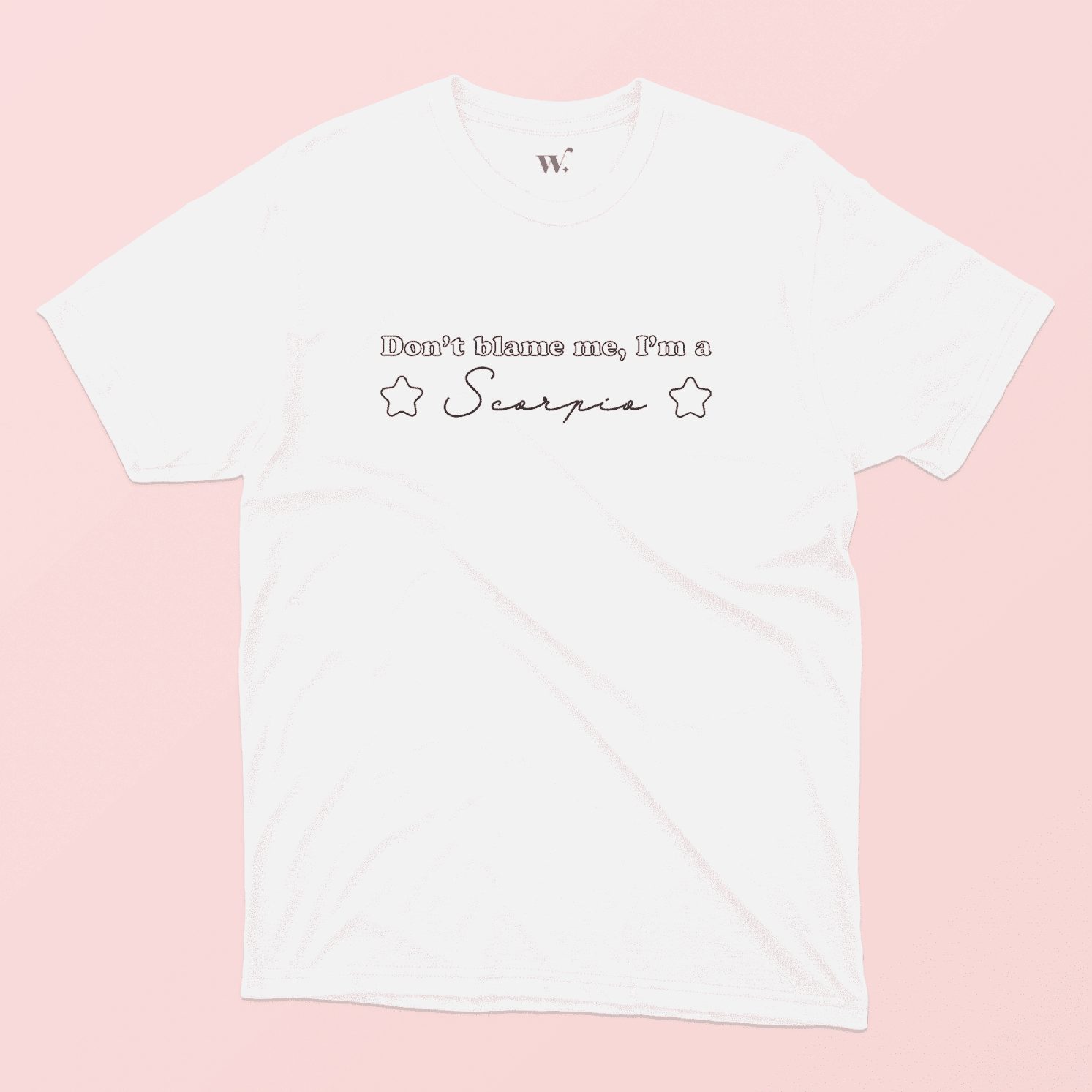 Don't blame me I'm a scorpio illustrated white t-shirt on a pink background