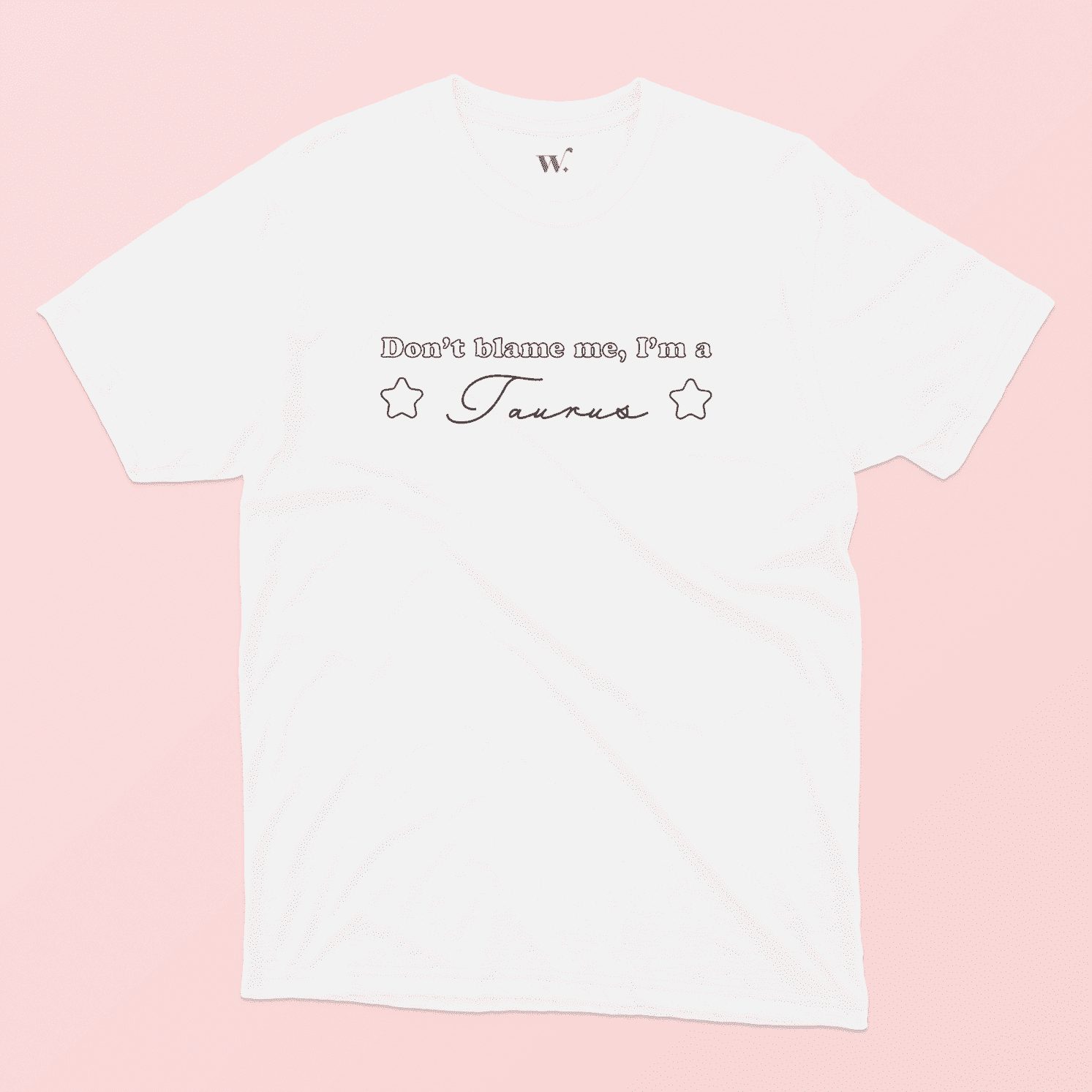 Don't blame me I'm a Taurus illustrated white t-shirt on a pink background