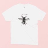 Bee Happy illustrated white t-shirt on a pink background