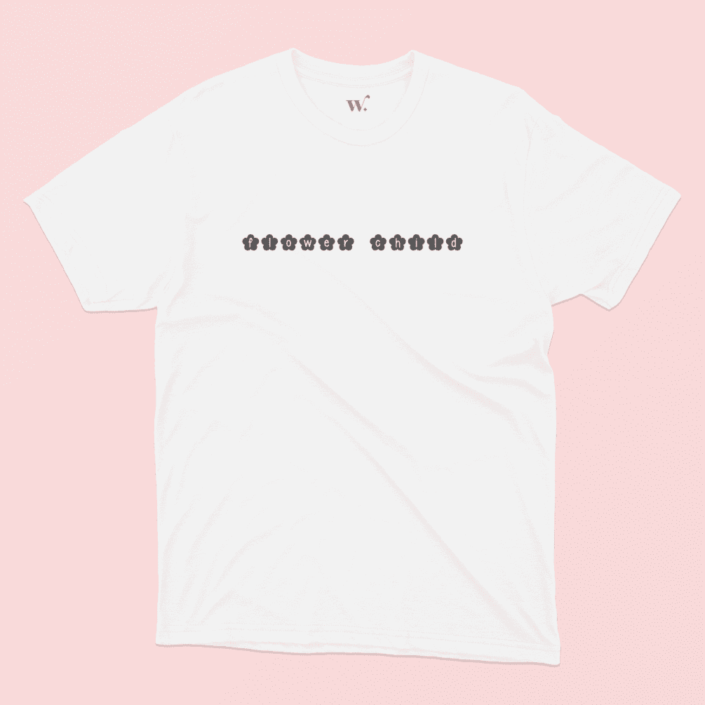 Flower Child illustrated white t-shirt on a pink background