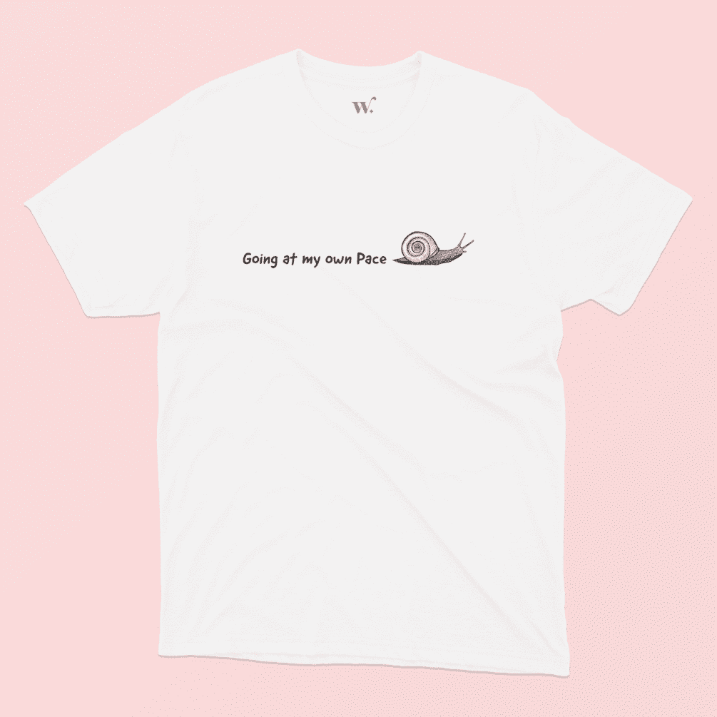 going at my own pace illustrated white t-shirt on a pink background
