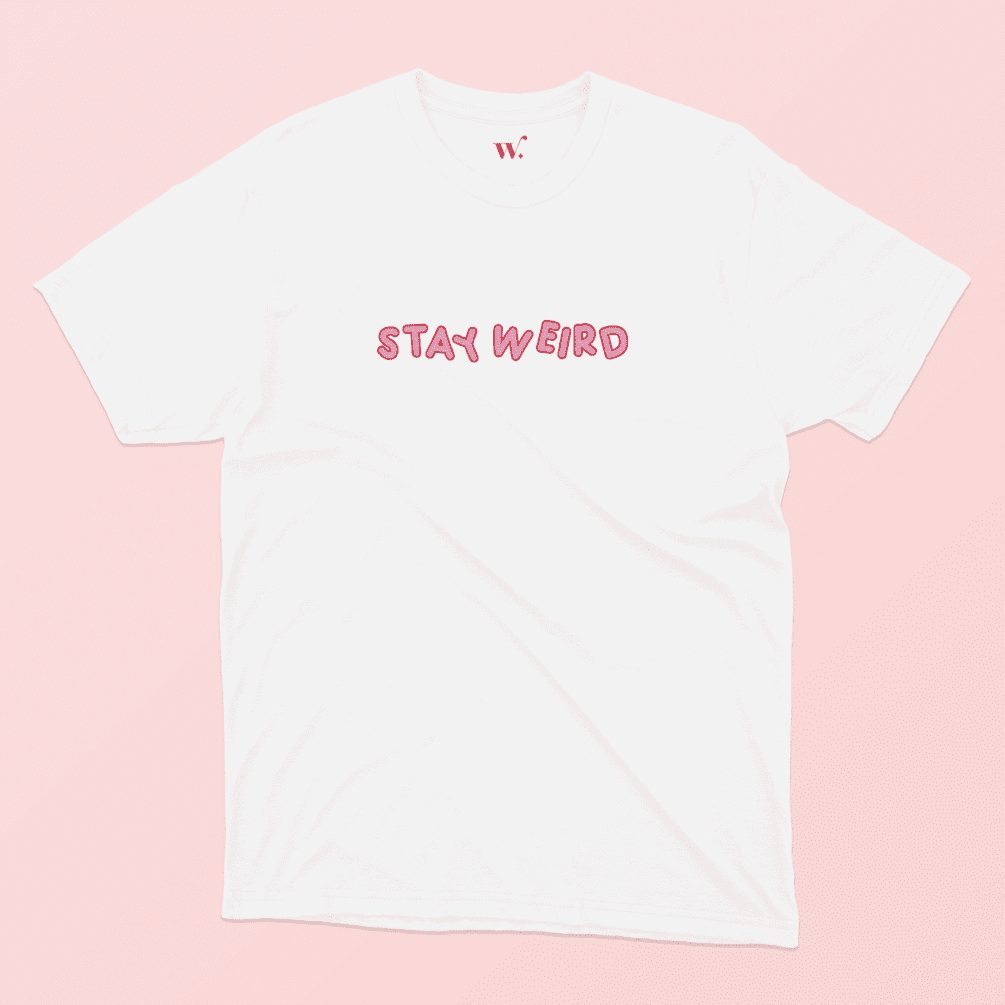 Stay Weird Illustrated T-Shirt Design in White on a Pink Background
