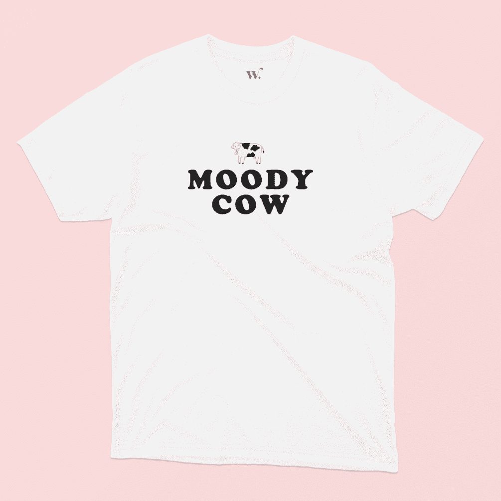 Moody Cow T-shirt Illustrated in White on a Pink background