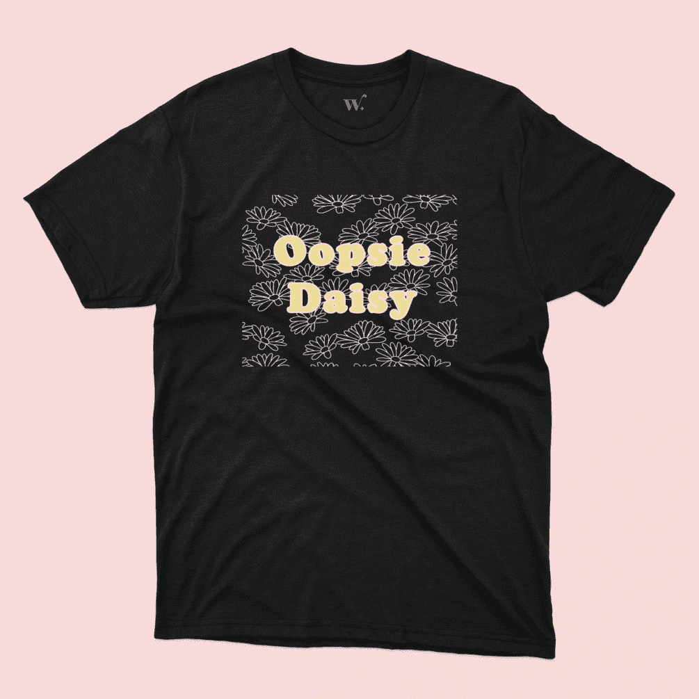 A Black t-shirt with the text "Oopsie Daisy" and an illustrated pattern on a pink background, sold by Willow Designs.