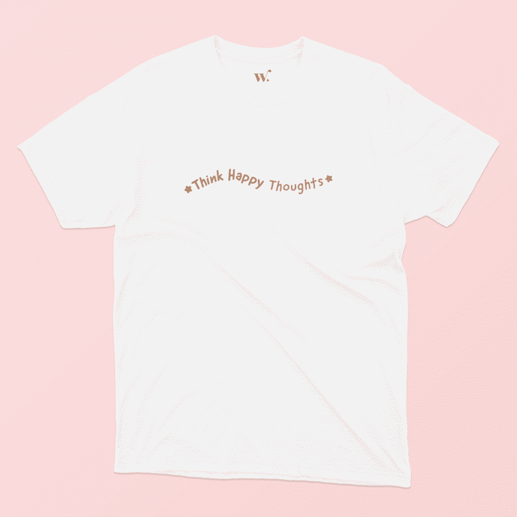 Think Happy Thoughts Illustrated T-shirt in White on a Pink Background